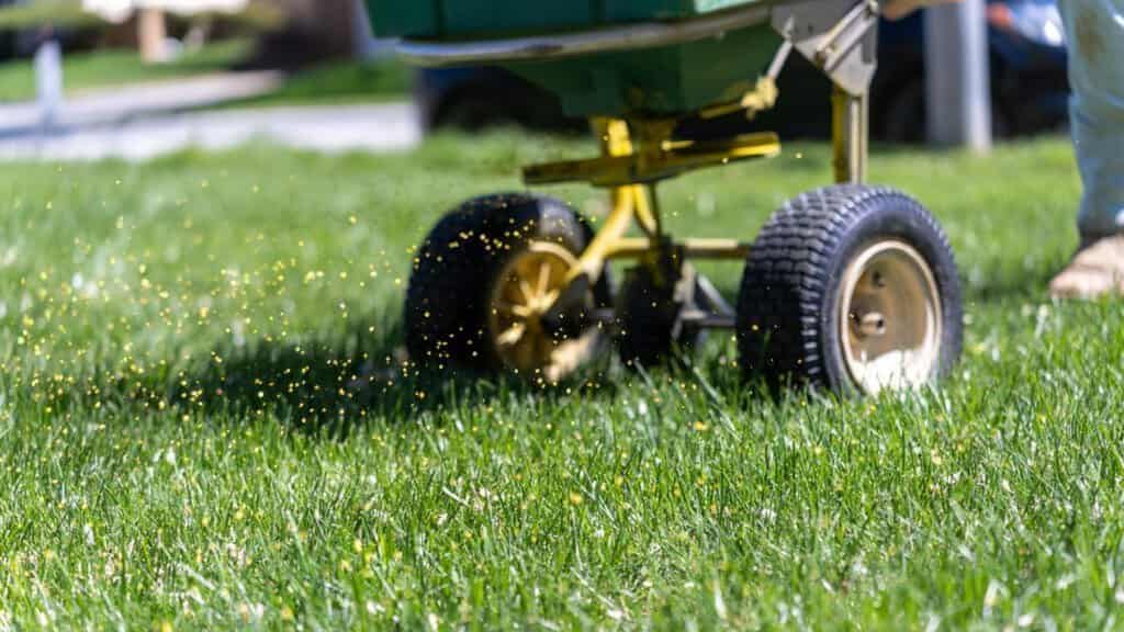 photo of a fertilizer spreader in action for commercial lawn care services post on SunCo.com